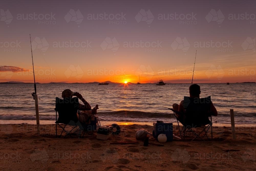 Beach fishermen at sunset. - Australian Stock Image