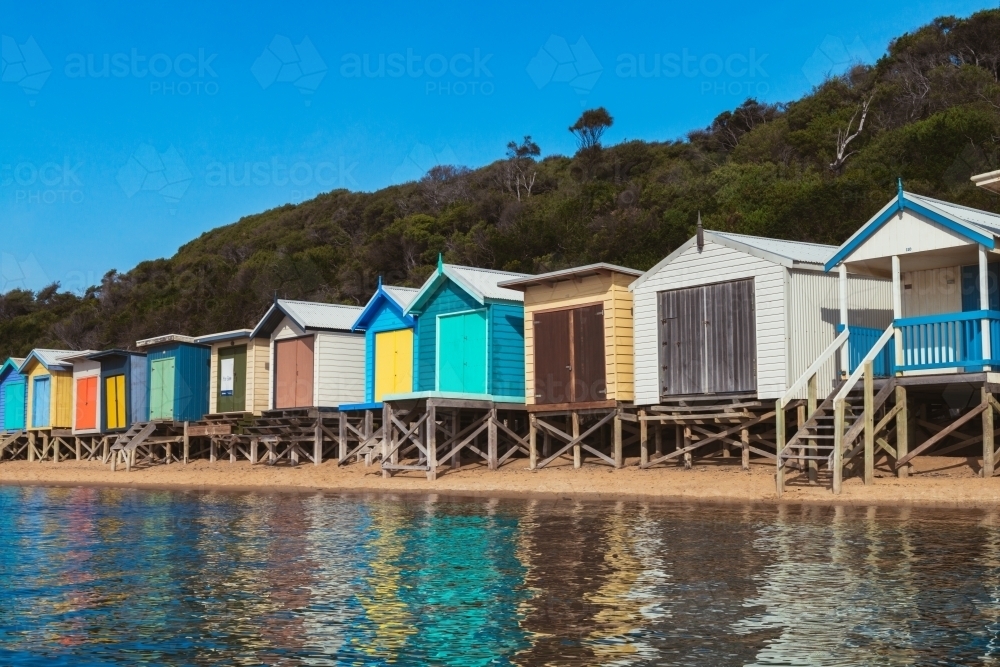 Beach huts at Mt Martha with water in the foreground - Australian Stock Image