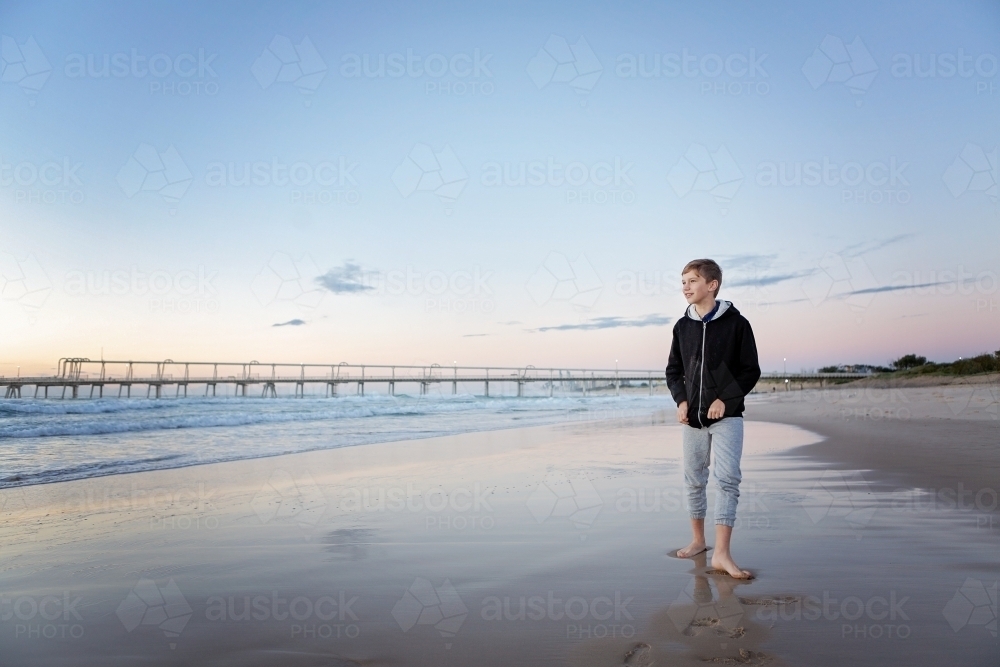 Beach reflections with boy - Australian Stock Image