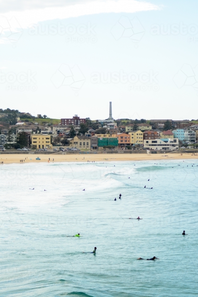 Beach scene with surfers in the water - Australian Stock Image