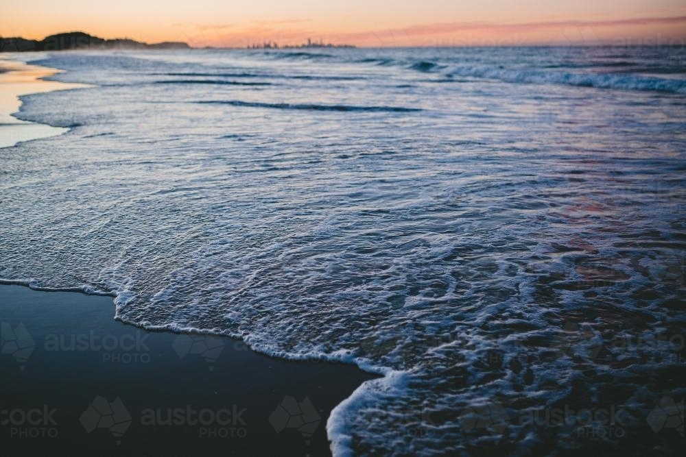 Image of Beach shoreline at sunset - Austockphoto