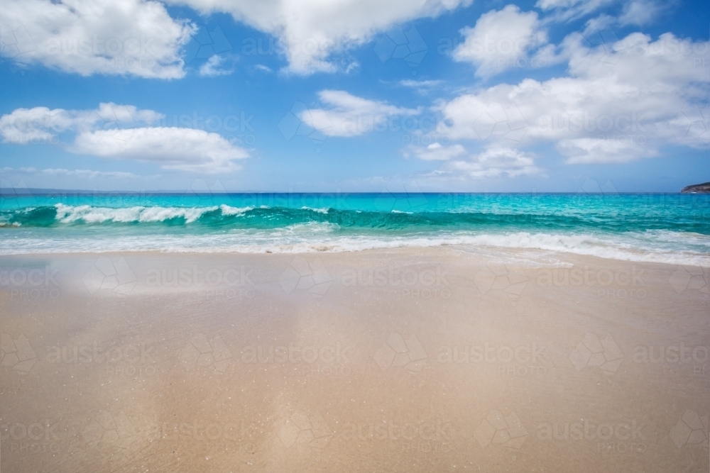 beach with white sand and blue water - Australian Stock Image