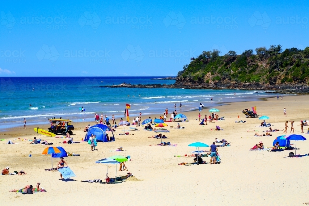 Beachgoers enjoying summer at Coolum Beach, Sunshine Coast, Queensland - Australian Stock Image