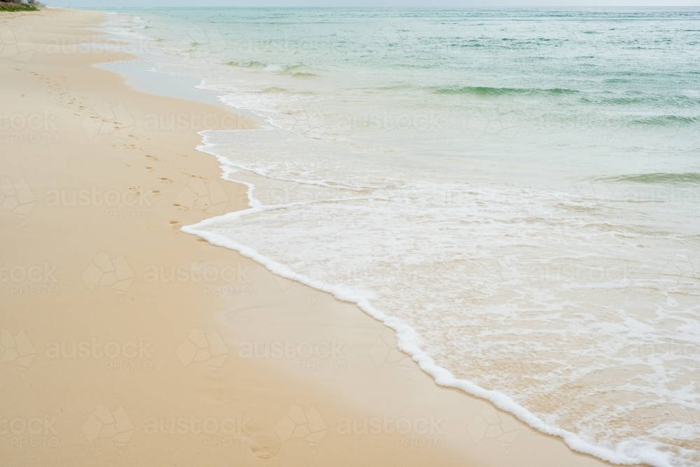 Beautiful clear water lapping the shore at the beach - Australian Stock Image