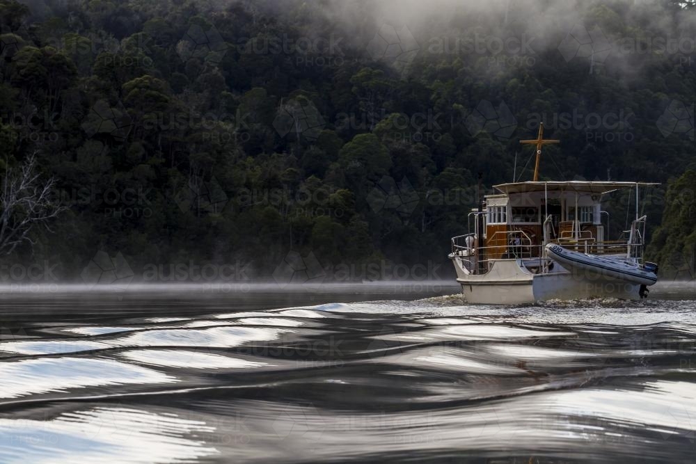 Beautiful old wooden boat on the water from behind - Australian Stock Image