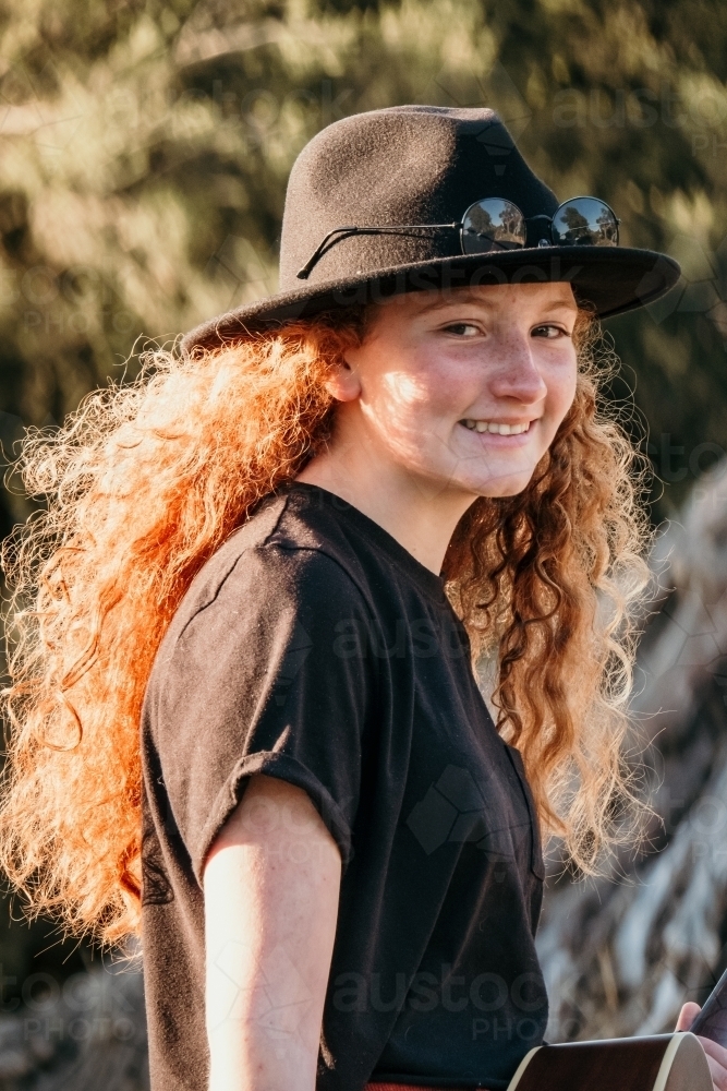 Beautiful red headed teenager smiles at camera. - Australian Stock Image