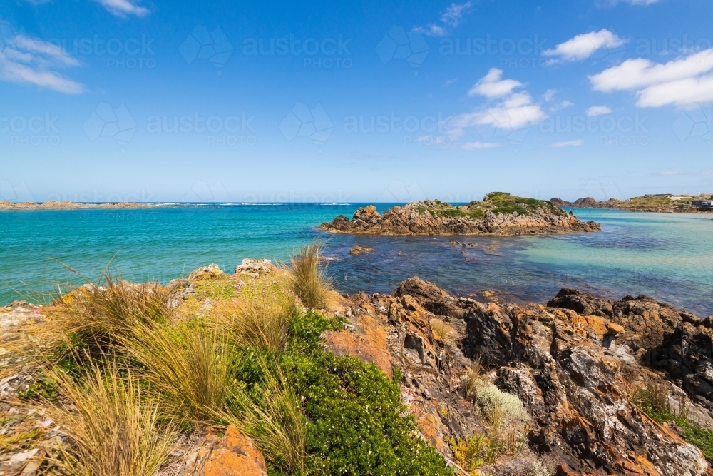 Beautiful rocky coastal scene with turquoise water and blue sky - Australian Stock Image