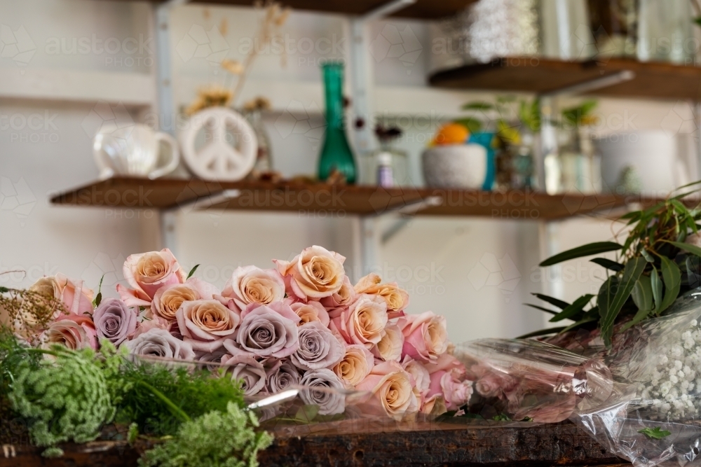 Beautiful roses on a workbench with blurred background - Australian Stock Image