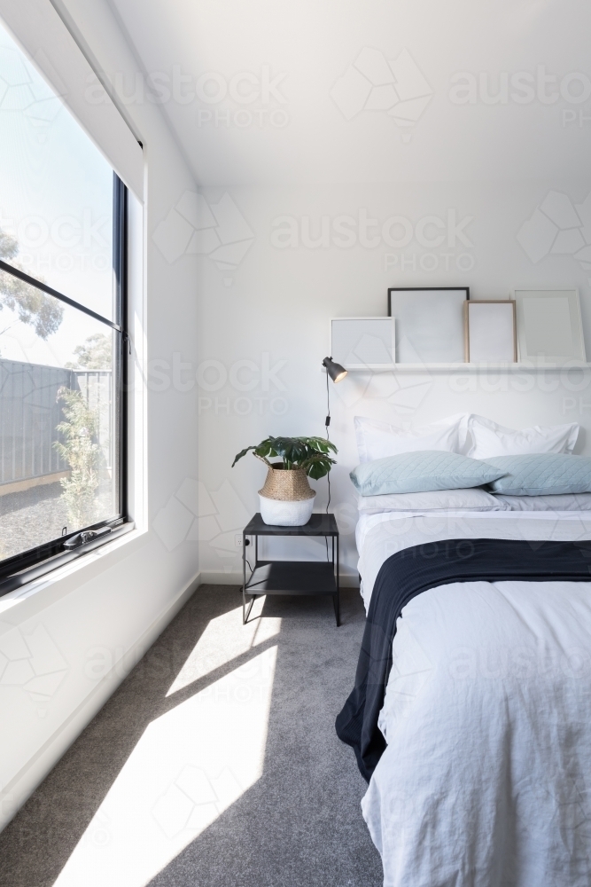 Beautiful sunlight beaming into a luxuriously styled bedroom - Australian Stock Image