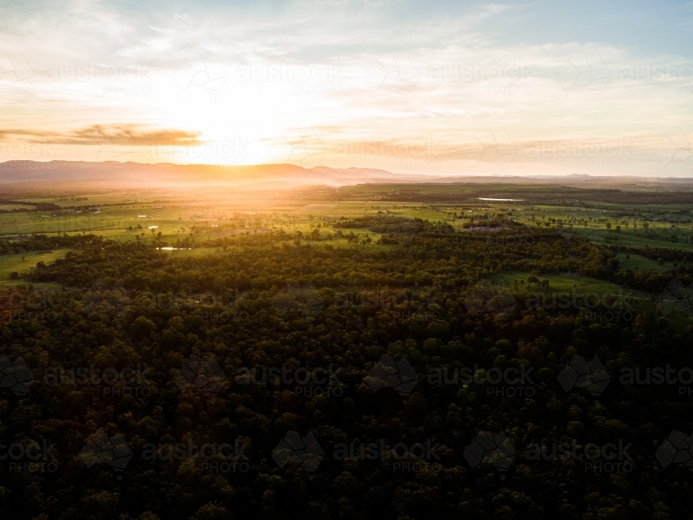 Image of Beautiful sunset light over landscape of trees and farm land ...