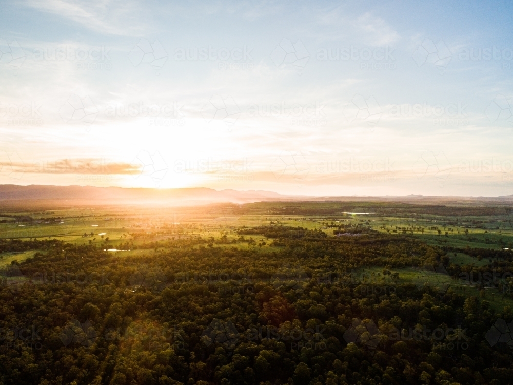 Beautiful sunset light over landscape of trees and farm land in Hunter Valley - Australian Stock Image