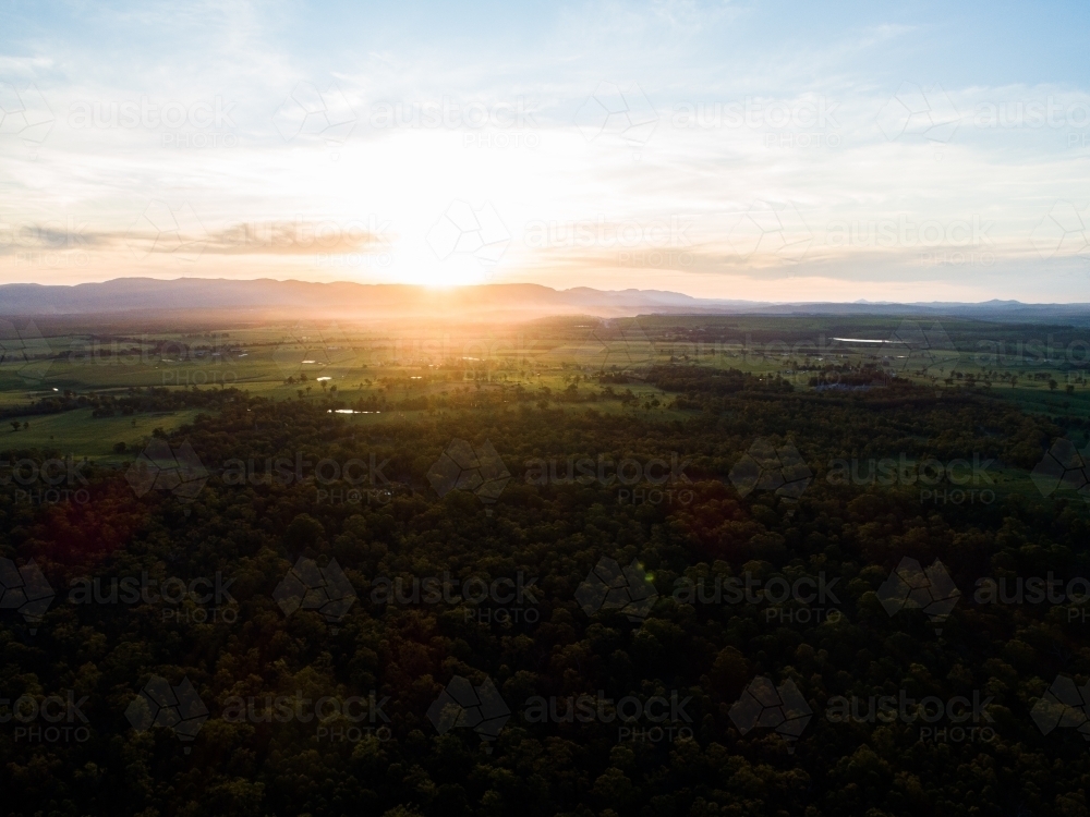 Beautiful sunset light over landscape of trees and farm land in Hunter Valley - Australian Stock Image