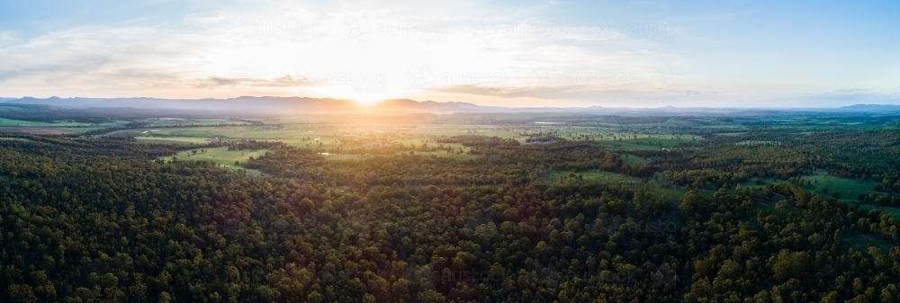 Beautiful sunset light over landscape of trees and farm land in Hunter Valley - Australian Stock Image