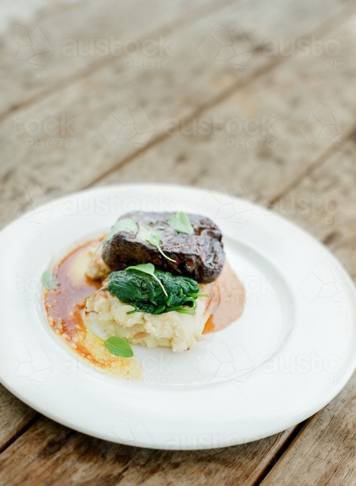 Beautifully plated meal of mash, greens and steak - Australian Stock Image