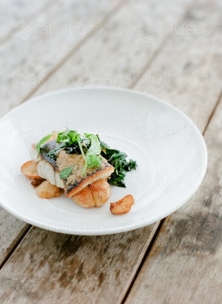 Beautifully plated meal of potatoes, greens and salmon - Australian Stock Image
