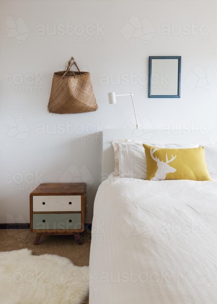 Bedroom details of retro decor side table and wall ornaments in 70s beach shack - Australian Stock Image