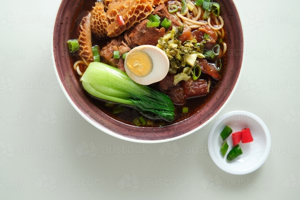 Beef gravy and tripe and tendon noodle soup - Australian Stock Image
