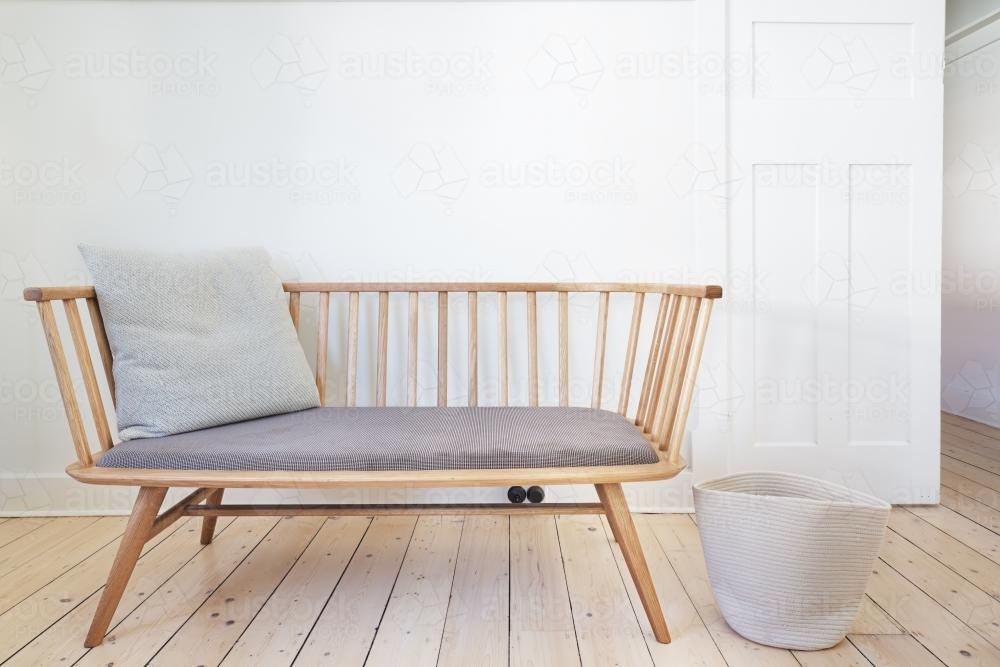 Bench seat feature chair in Danish styled white interior - Australian Stock Image