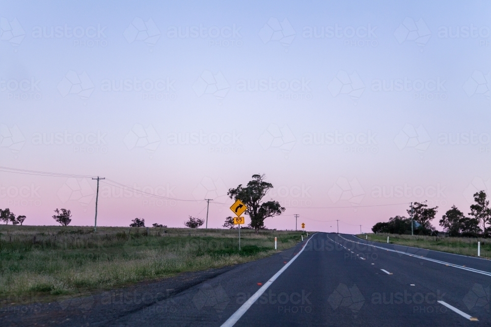 Bend in road coming up with recommended speed of 85 kph - Australian Stock Image