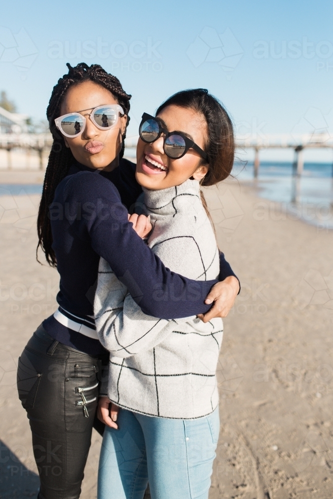 Best friends spending time on the beach laughing - Australian Stock Image