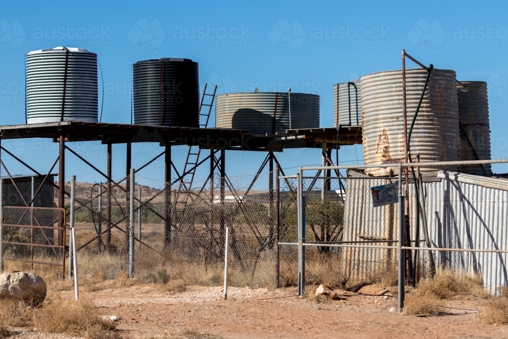 Image of Betoota Hotel water tanks on stand in the outback Austockphoto