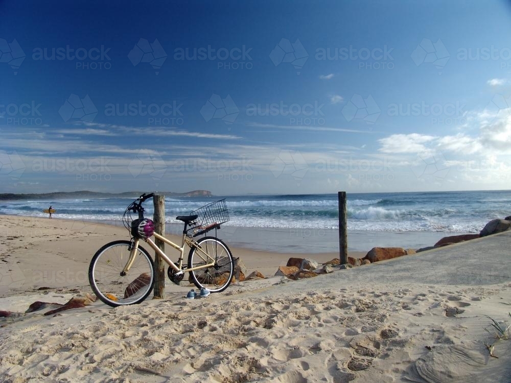 Bicycle parked at a post by the beach - Australian Stock Image