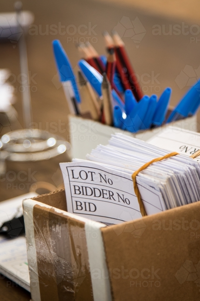 Image of Bidder cards and pencils at an auction - Austockphoto