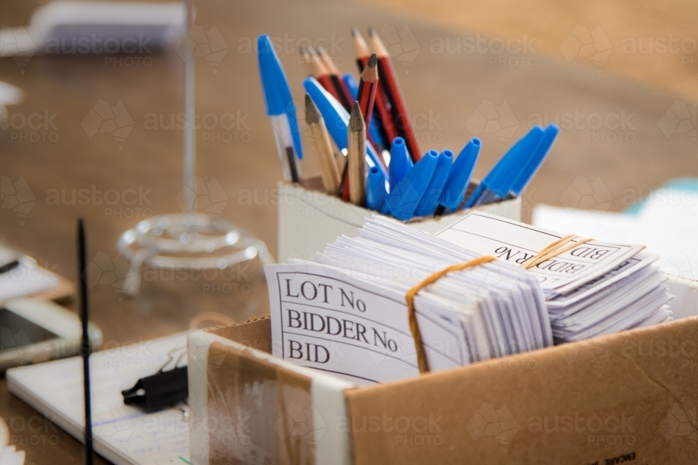 Bidding cards and pens at an auction - Australian Stock Image