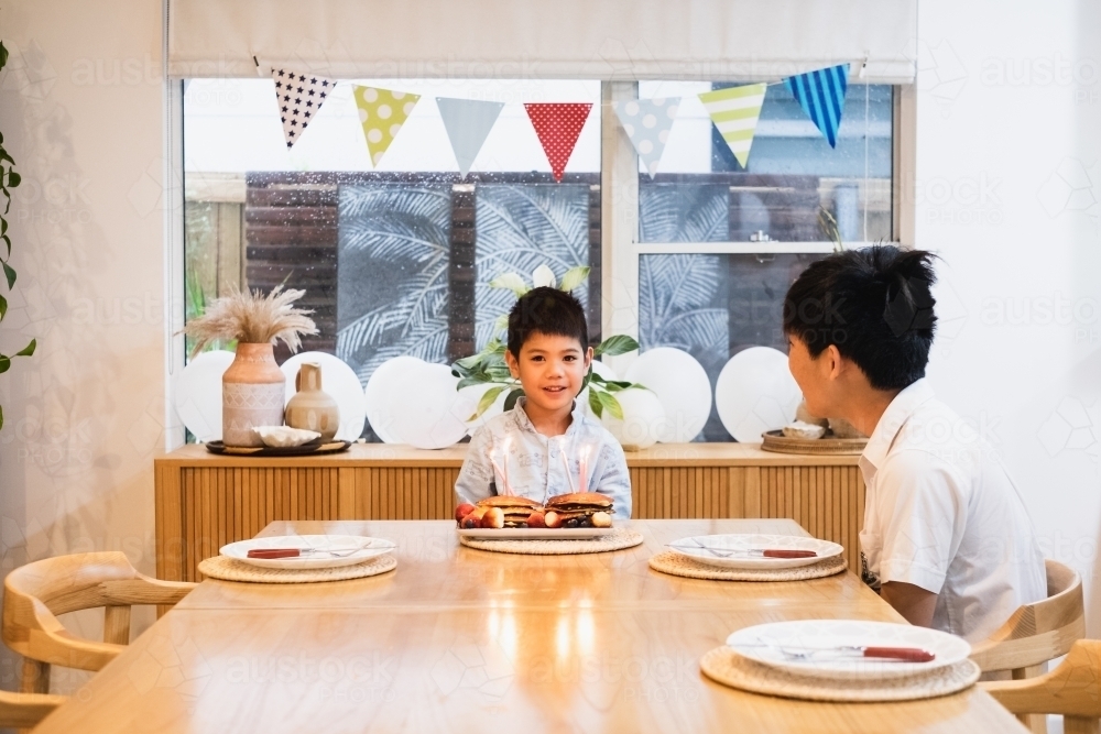 Big brother singing happy birthday to his younger brother - Australian Stock Image