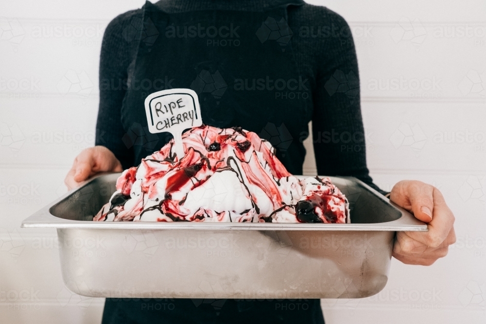 Big bucket of fresh made cherry ice cream. - Australian Stock Image