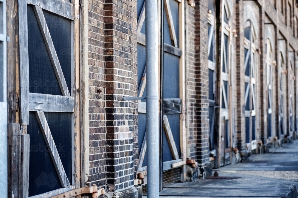 big old doors, closed and lined up at a warehouse - Australian Stock Image