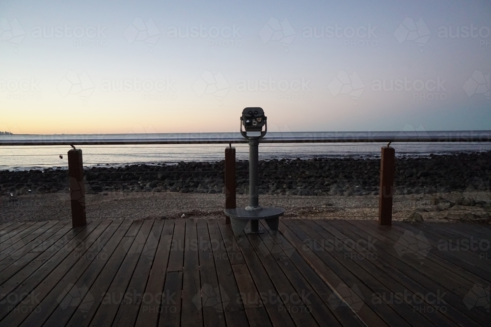 Binoculars look out over beach sunset - Australian Stock Image