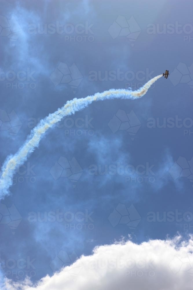 Biplane doing aerobatics in the distance - Australian Stock Image