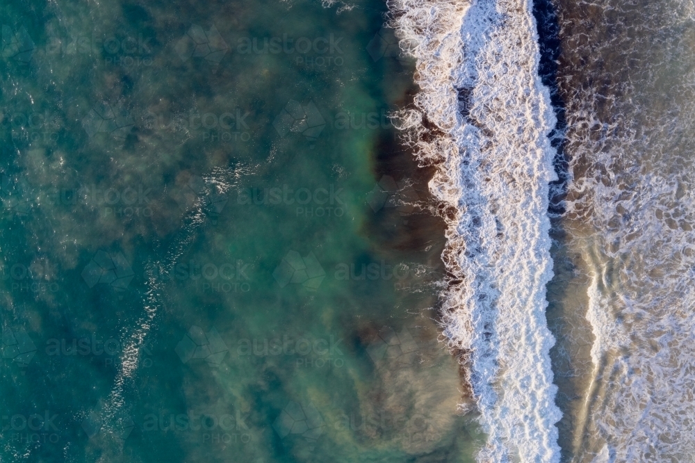 Bird's eye view of a wave on a West Australian beach. - Australian Stock Image