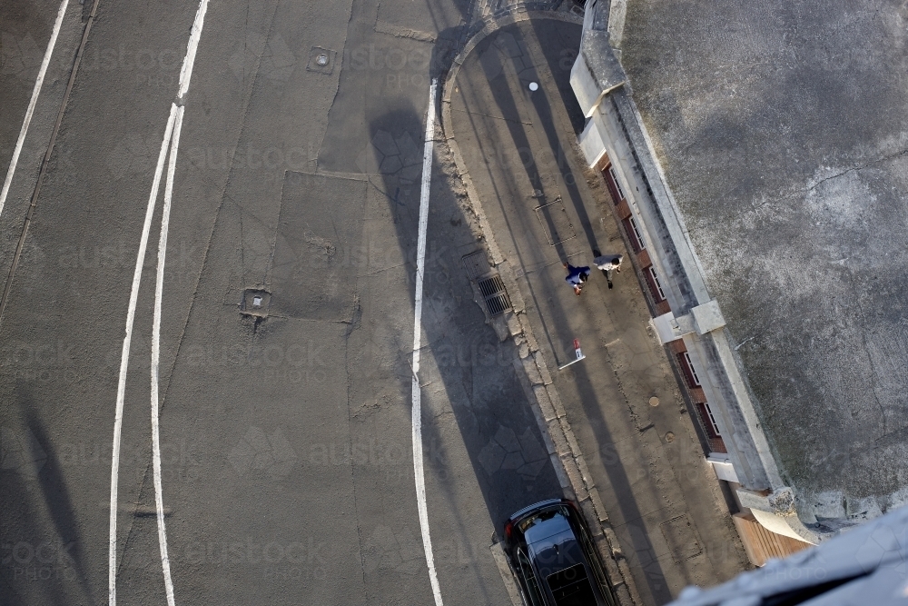 Birds eye view of two businessmen walking on the street - Australian Stock Image