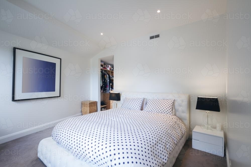 Black and white master bedroom with walk in wardrobe - Australian Stock Image