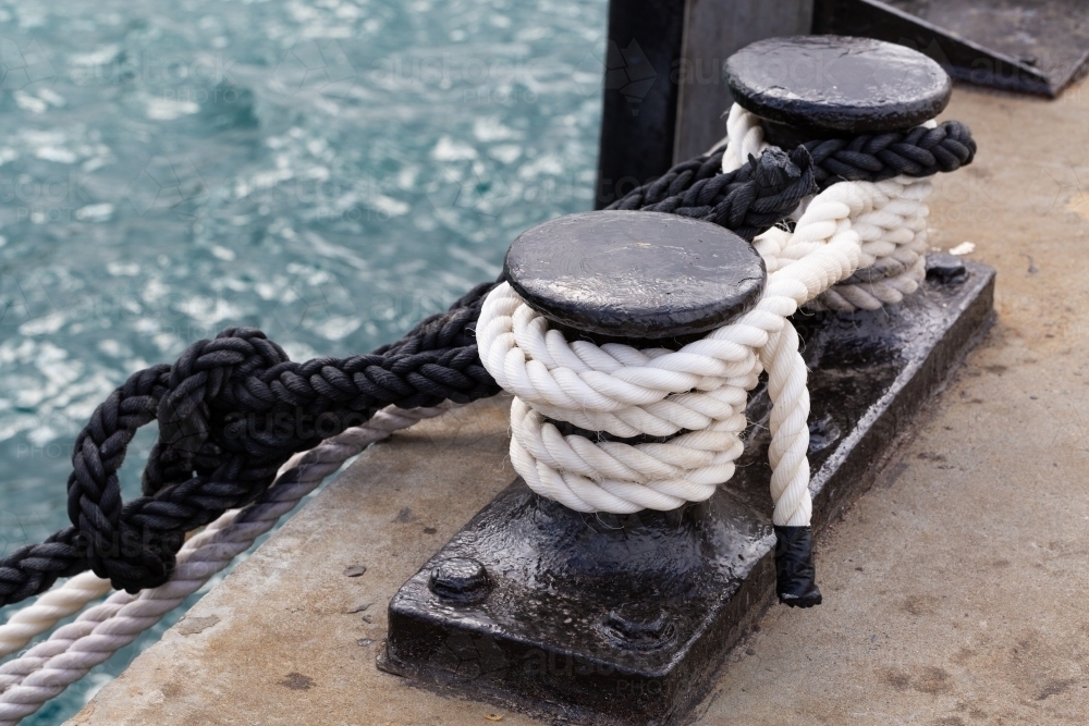 Black and white ropes tied off at a wharf - Australian Stock Image