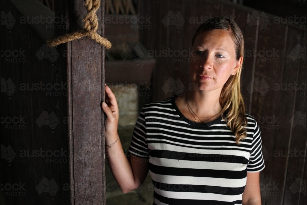 Blonde girl in dim light - Australian Stock Image