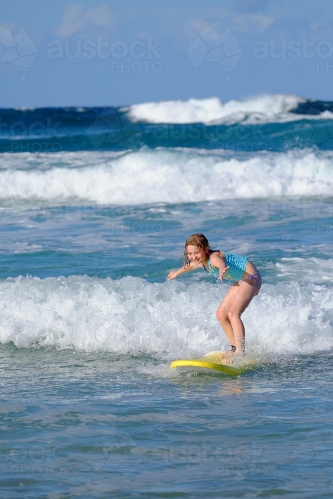 Blonde girl learning to surf on the Gold Coast - Australian Stock Image