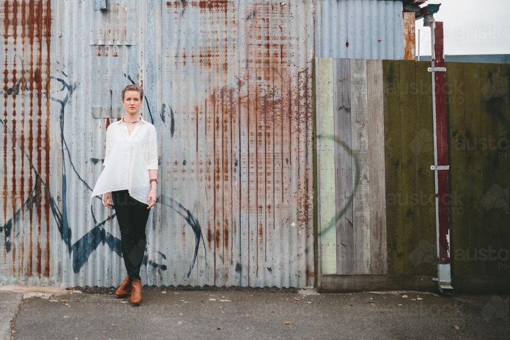 Blonde woman standing in a laneway - Australian Stock Image