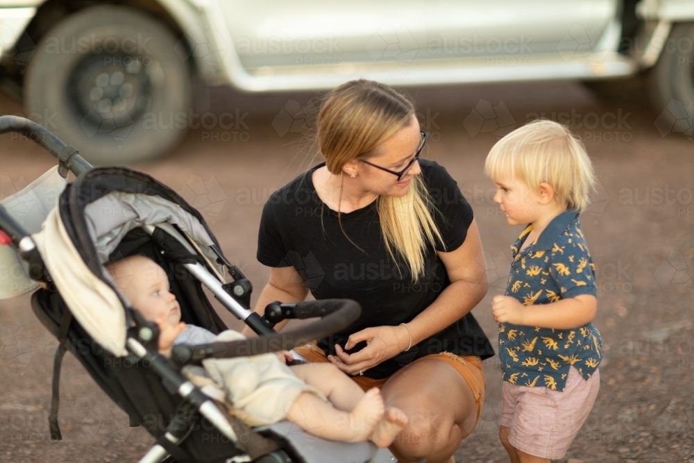 blonde woman with baby in pram - Australian Stock Image