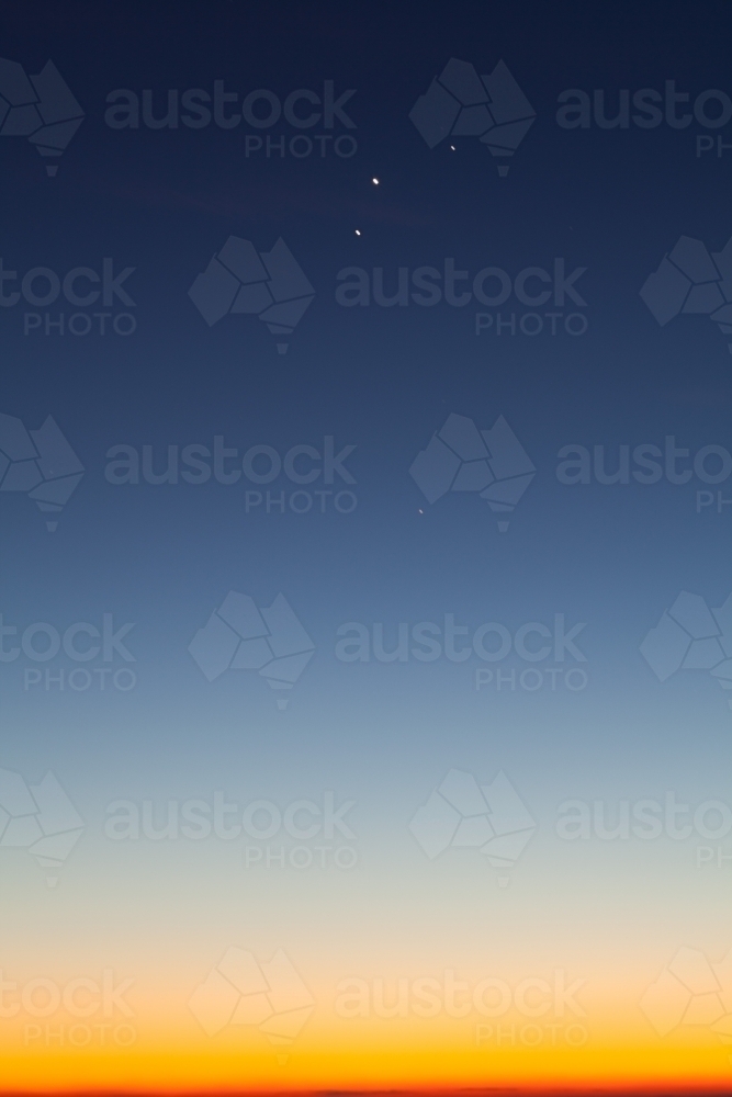 Blue and yellow dawn sky with planets aligned - Australian Stock Image