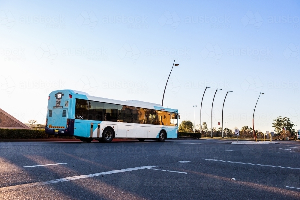 Image of Blue bus on road in town - public transport system - Austockphoto