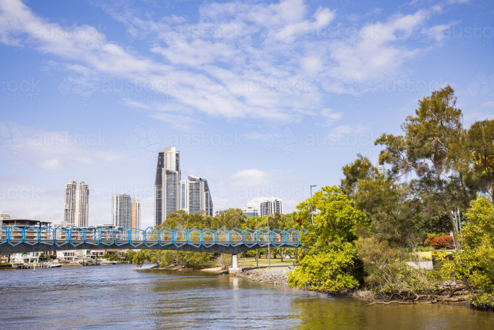 Blue footbridge walkway over the Nerang River at the Home of The Arts on the Gold Coast - Australian Stock Image