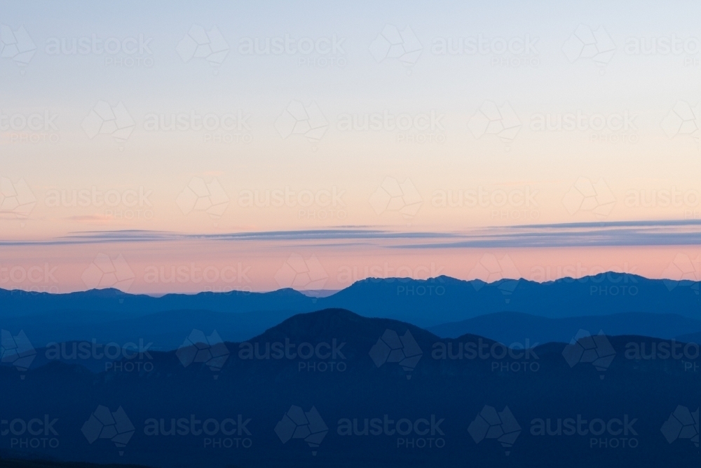 Blue hour falling on mountain ridges - Australian Stock Image