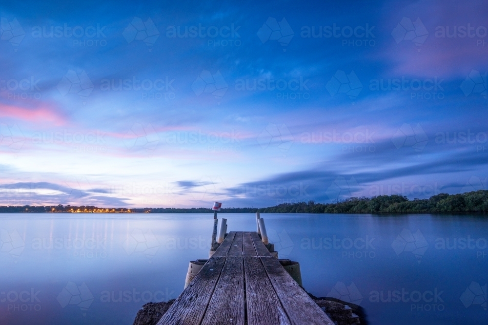 Blue hour on the Tweed river on a pier looking out. - Australian Stock Image