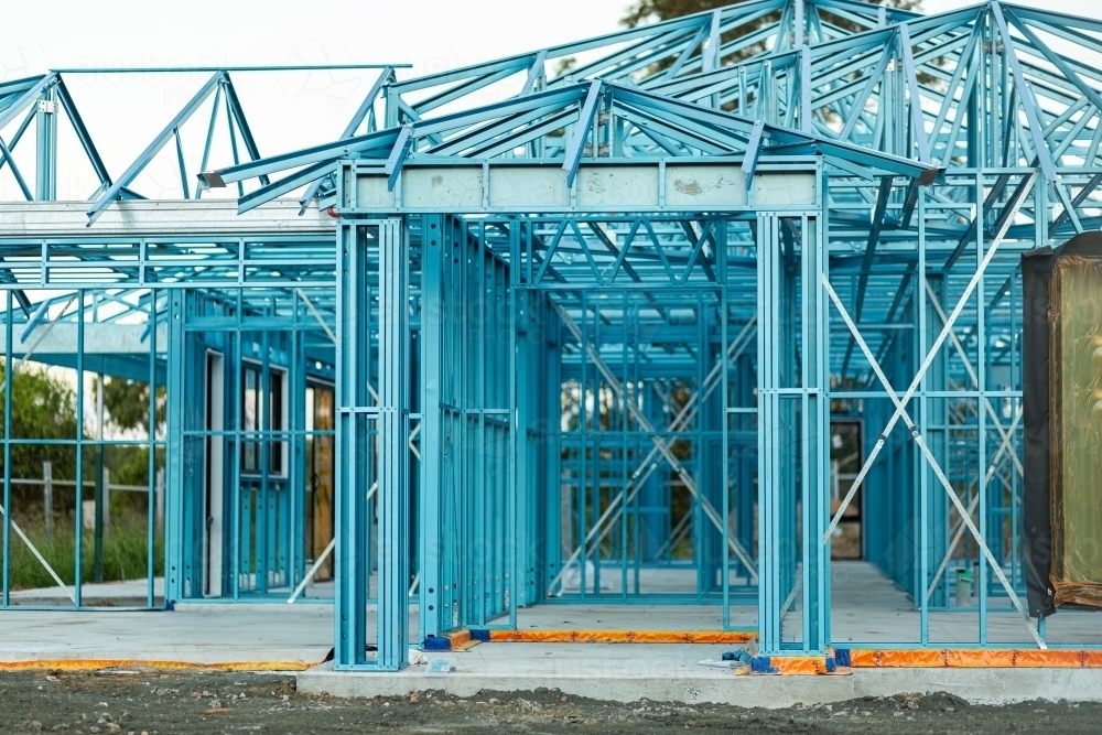 Blue metal frame structure of house being built - Australian Stock Image