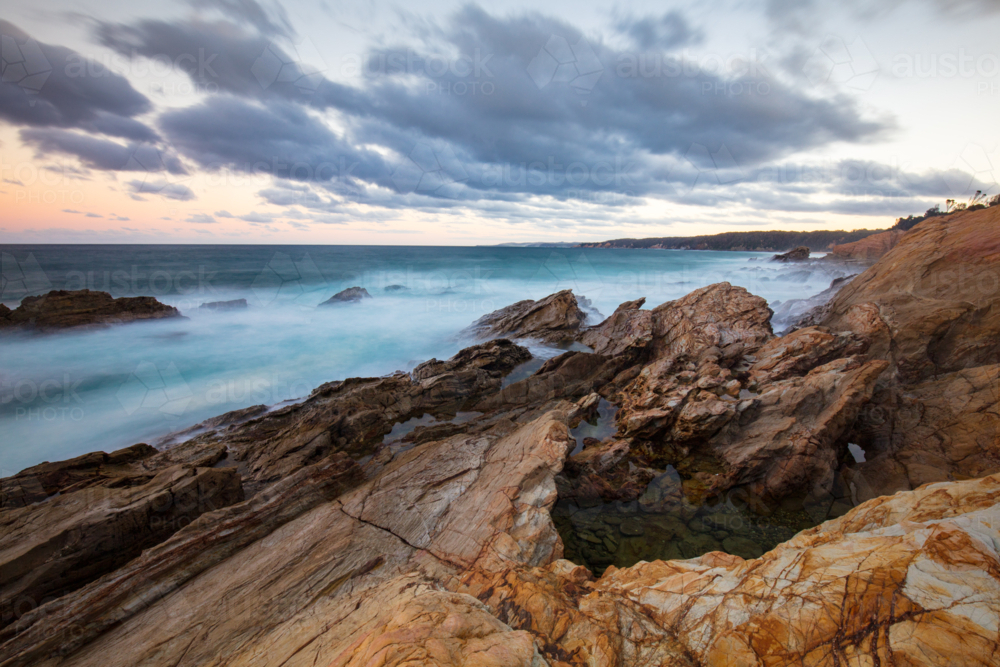 Blue Pool on a cool autumn evening in Bermagui, New South Wales, Australia - Australian Stock Image