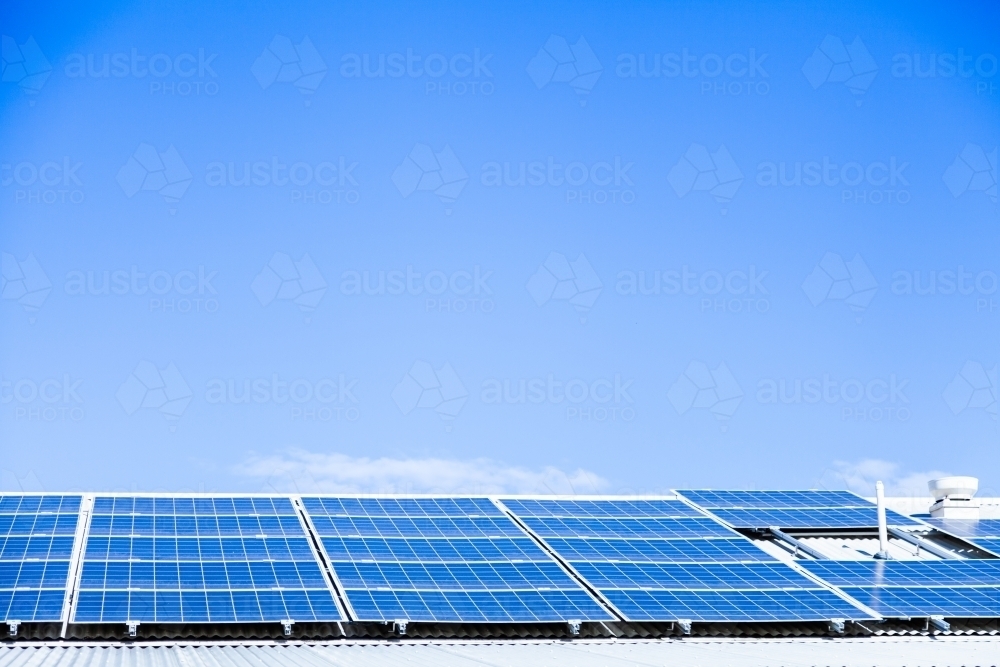 Blue sky and solar panels on building roof - Australian Stock Image