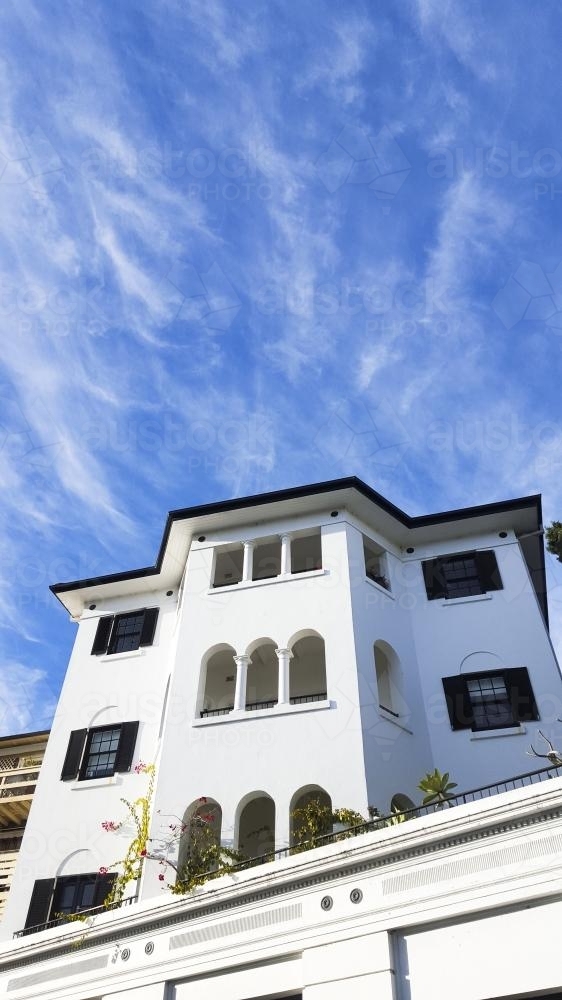 Blue sky, clouds and a white building in the eastern suburbs, Sydney - Australian Stock Image